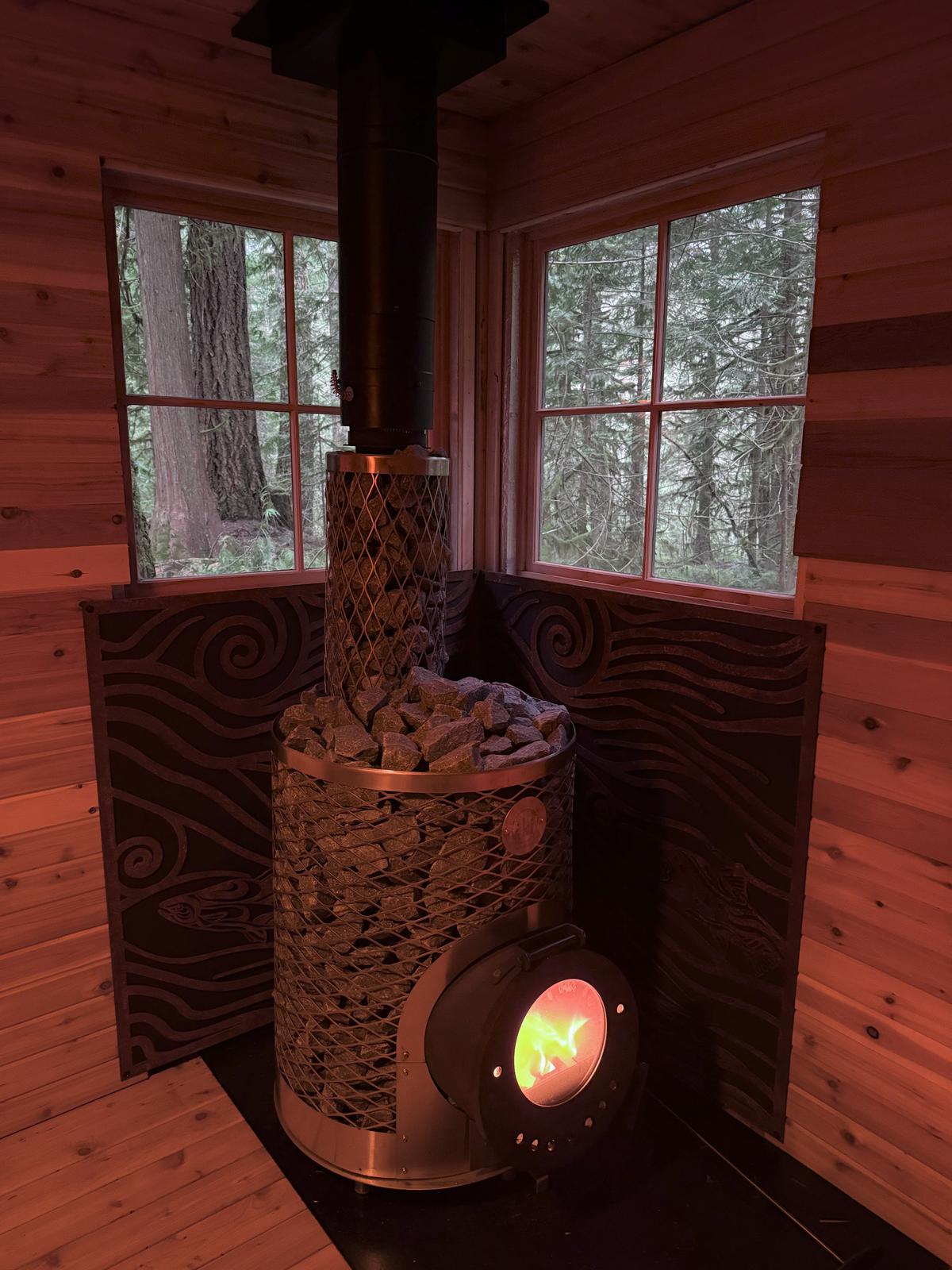 Stove with fire glowing through heat shield