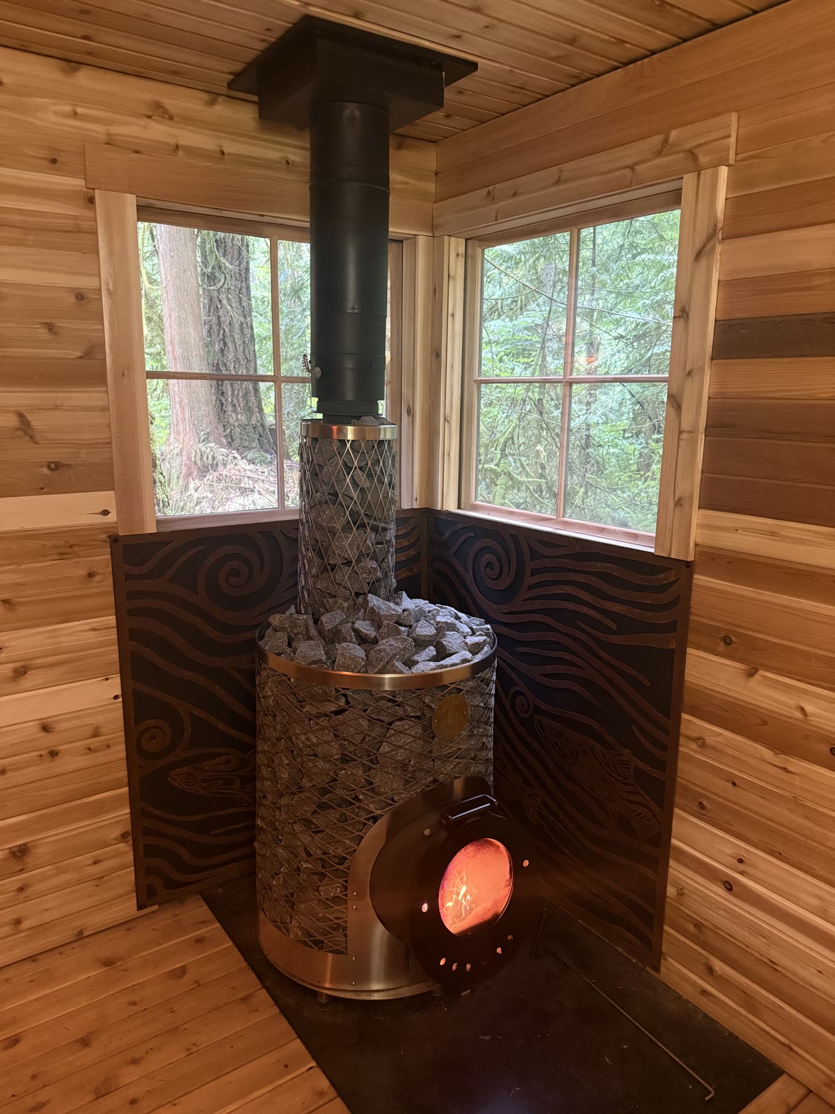 Stove with fire glowing through heat shield